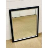 A contemporary bevelled mirror in a black and chrome effect frame (74cm x 62cm)