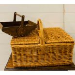 A wicker hamper and wooden tray