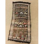 A hand knotted prayer mat or wall hanging from Tunisia measuring approx. 140cm x 50cm