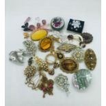 A selection of costume jewellery, mainly brooches