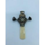 A Silver an ivory baby rattle and whistle hallmarked Birmingham 1918 , makers mark C & N.