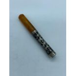 A decorative silver and amber cheroot or cigarette holder.