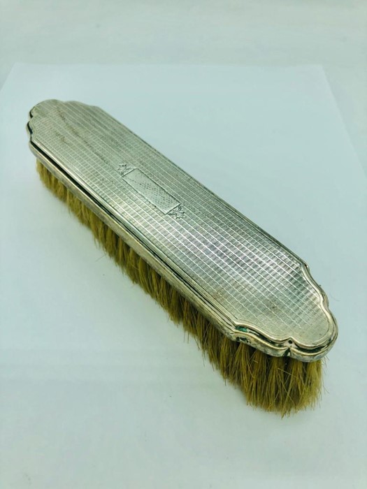 A hallmarked silver brush