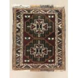 A Turkish rug in deep red, tan, green and cream measuring 146cm x 118cm