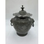 A pewter lidded jar with lion handles to side