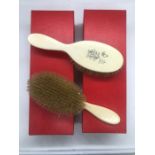 A pair of monogrammed Ivory clothes brushes
