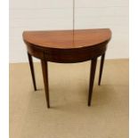 A demi lune fold over card table with glass top