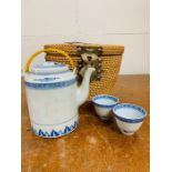A blue and white Chinese tea set in a basket
