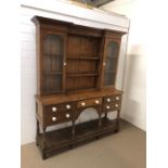 A medium Welsh dresser, pine backed with of two glazed cupboards either side with internal shelving,