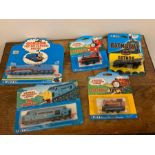 Five diecast Thomas the Tank Engine trains and a batmobile