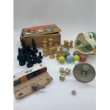 A selection of games to include wooden chest pieces, vintage die, marbles and bridge accessories