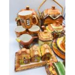 A quantity of Cottage Ware to include two biscuit jars, three mugs, one teapot, one honey pot, one
