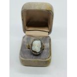 A Georgian closed back button ring with cameo decoration.