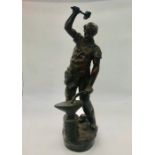 A spelter figure of a blacksmith