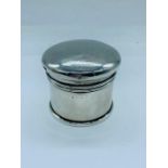 A hallmarked silver lidded pot.