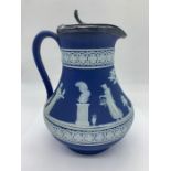 A Wedgwood jug with white metal lid.