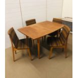 A Mid Century extendable dining table with four upholstered chairs