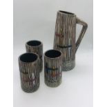 A studio pottery jug and three beakers