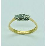 A three stone diamond ring on 18 ct gold and platinum setting.