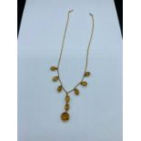 A 9 ct gold necklace with graduated citrine stones and pendant.