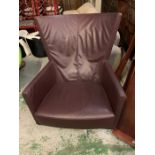 A 1970's burgundy leather swivel designer lounge chair