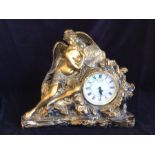 A clock in resin with angelic figure.