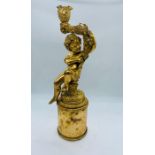 A gilt cherub candle holder (36cm x 9cm)