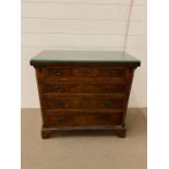 A small mahogany chest of drawers with fold out writing extension