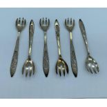 A set of six silver pickle forks stamped S-500 with filigree handles