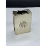 A silver matchbox cover, monogrammed.