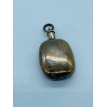 A silver bottle charm.