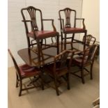 A mahogany dining table with six chairs and two carvers