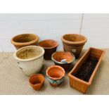 A selection of eight terracotta and white painted garden pots, various sizes and shapes