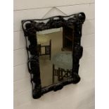 A wooden carved decorative mirror