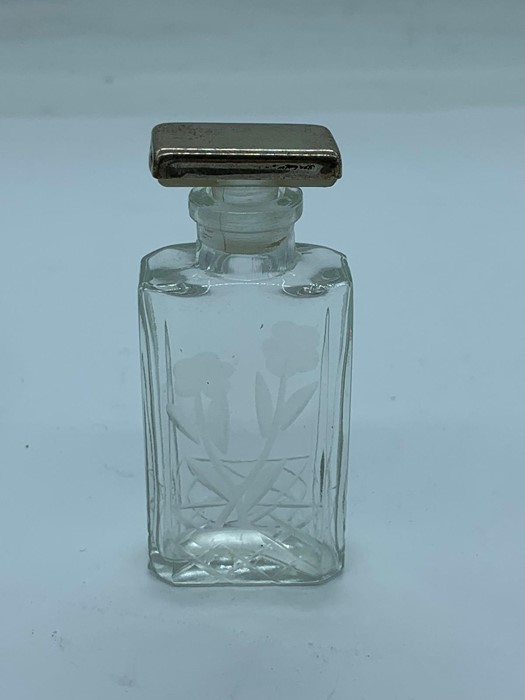 A silver topped scent bottle.