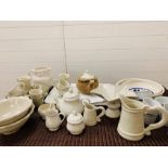A mixed selection of white pottery to include, cups and saucers, serving bowls, milk jugs, teapot