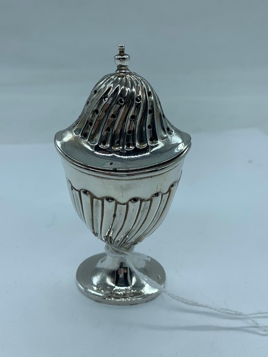 A silver pepper pot, hallmarked Birmingham.