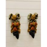 A pair of wooden decorative wall hangings