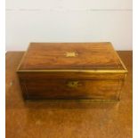 A brass bound writing box with red leather fitting.