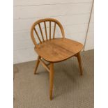 An Ercol low wheel back chair in golden oak