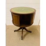 A drum table with a green leather top