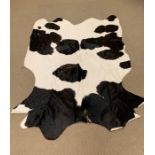 A black and white cowhide rug