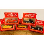 Five boxed Coca Cola diecast model cars