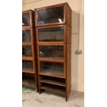 A Mahogany Sectional Bookcase with up and over glass doors to each section, in a Globe Wernicke