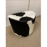 A faux cowhide foot stool