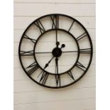 A Roman numeral large metal wall clock