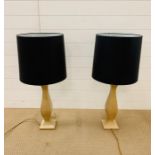 A pair of contemporary wooden lamp bases with black shades