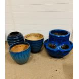 A selection of four various shapes and sizes blue/green glazed garden pots