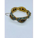 An Arabian silver bracelet with turquoise and tigers eye decoration