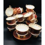 A "Sovereign" Elizabeth gold and maroon Staffordshire, twelve cup and saucers, twelve tea plates,